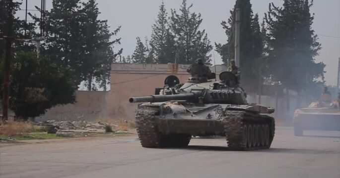 Rebels drive military vehicles in Syria's Aleppo province as violence escalates
