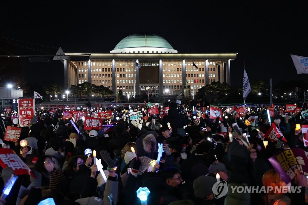 Rally participants in front of the National Assembly in Seoul call for the impeachment of President Yoon Suk Yeol
