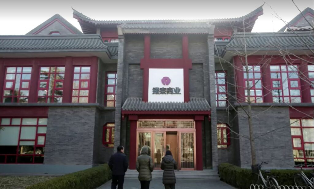 Employees walking in front of Intime Retail Beijing office building