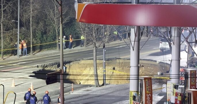 Rescue authorities inspect a sinkhole at an intersection in Seoul's eastern ward of Gangdong