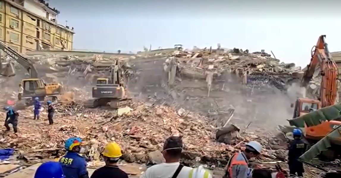 Diggers clear debris at site of collapsed Myanmar condominium