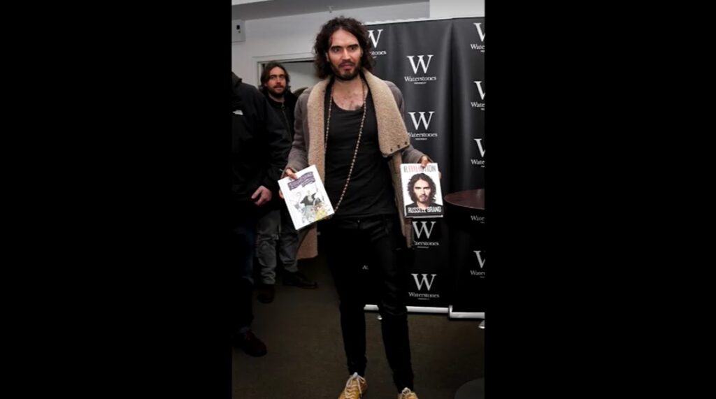 Russell Brand with his book in 2014