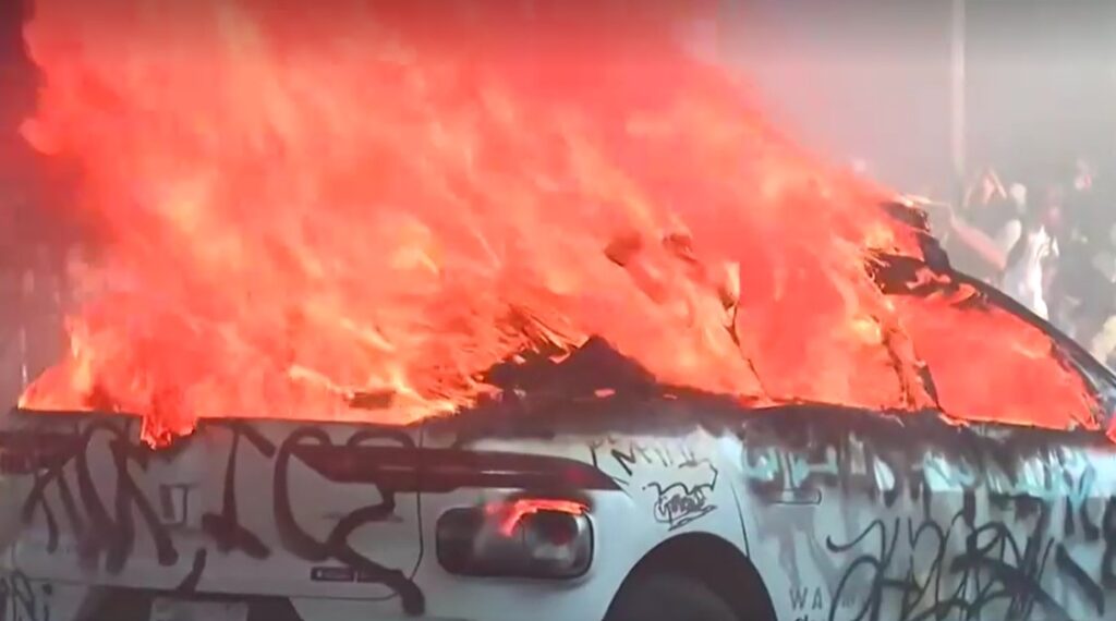 protesters burn car to protest against ICE